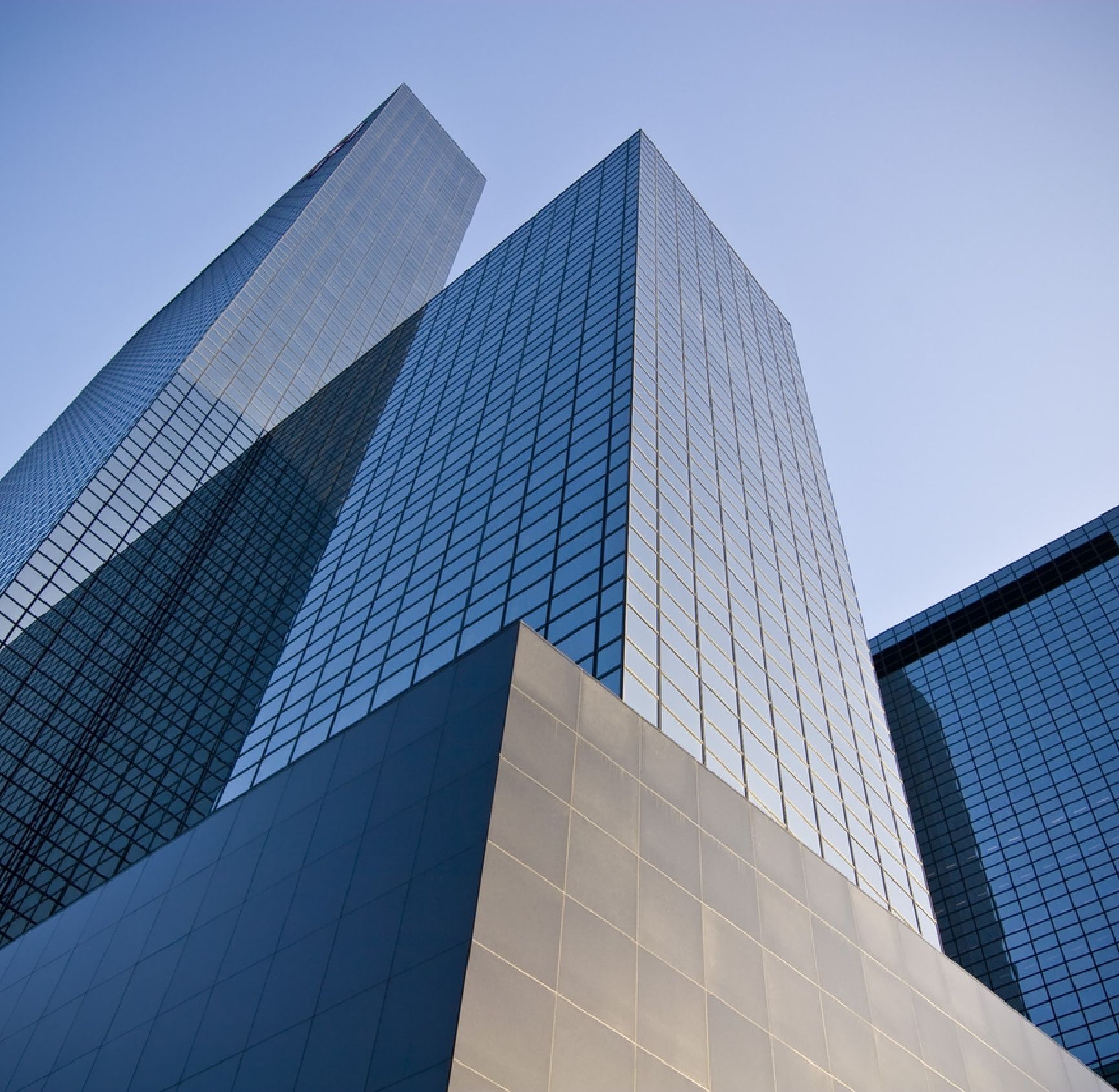 Modernes Bürogebäude aus Glas von unten unter blauem Himmel bei wirtschaftsforum